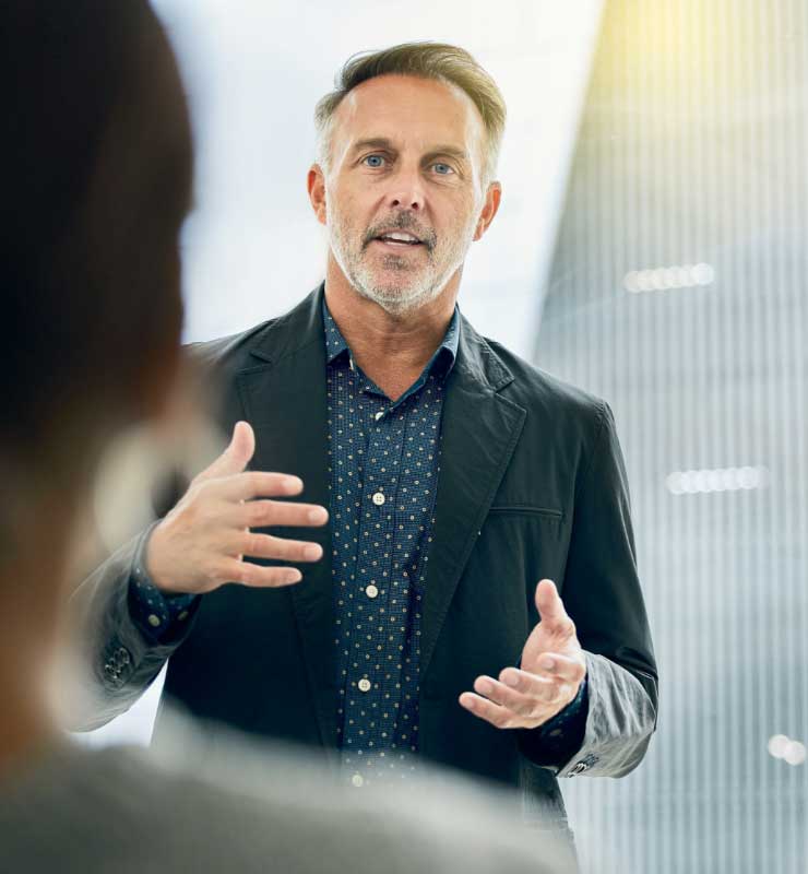 Shot of a CEO giving his staff a presentation.